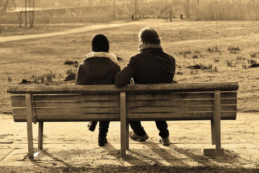 couple talking on a bench