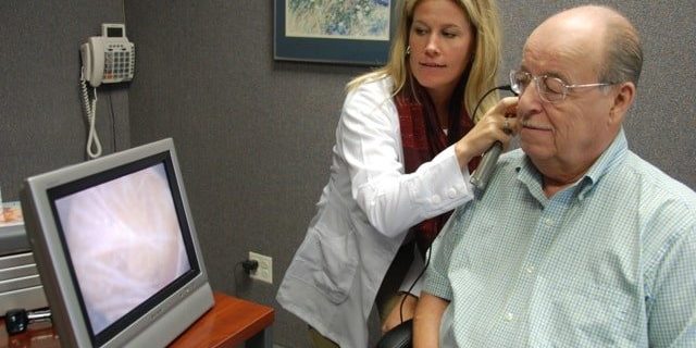 Audiologist testing hearing loss