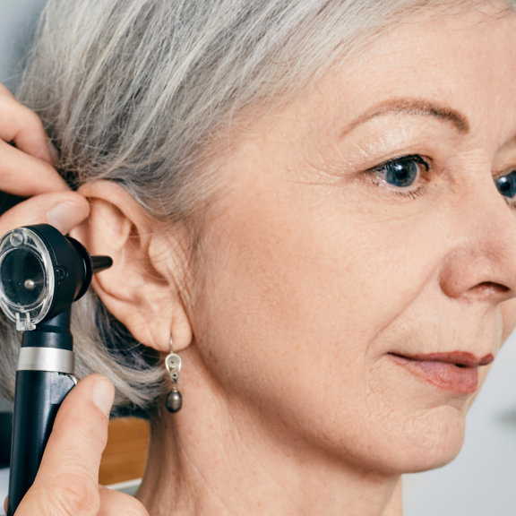 tinnitus woman getting her ears checked at the audiologist